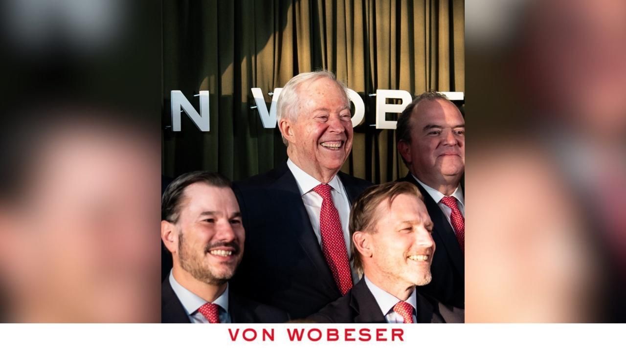 Anniversary attendees in front of the Von Wobeser y Sierra backdrop